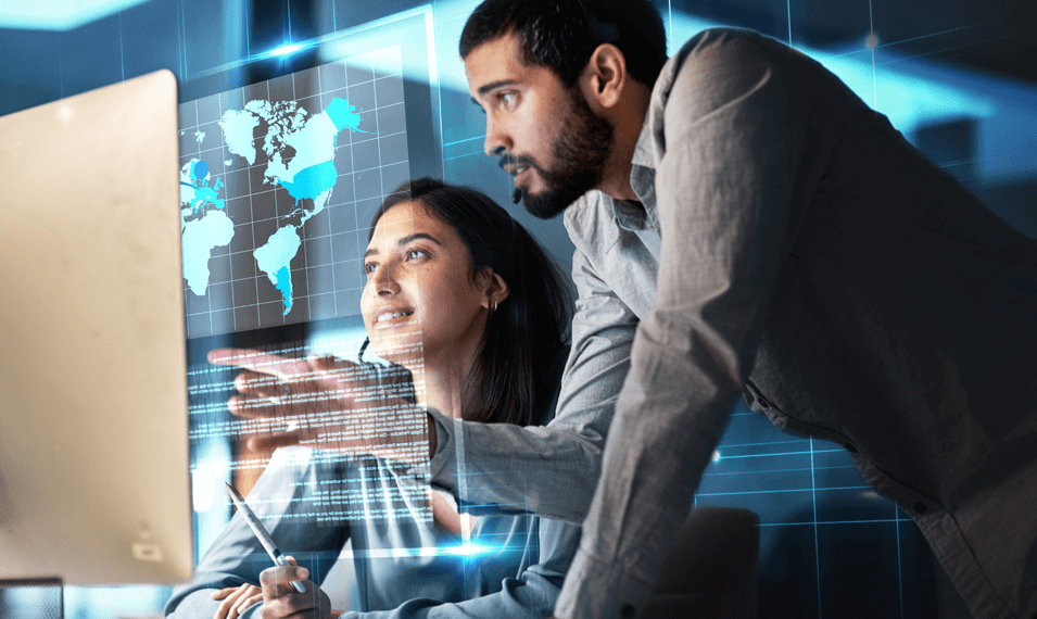 Colleagues looking at computer with 3d hologram for global network planning and performance management